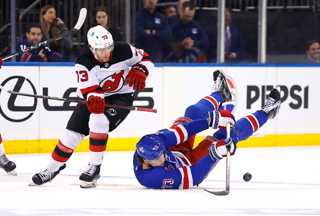 New Jersey Devils right wing Dylan Wendt (73) and New York Rangers center Matt Rempe (73) battle for the puck during the first period of a NHL hockey game, Tuesday, Oct. 1, 2024 in New York.