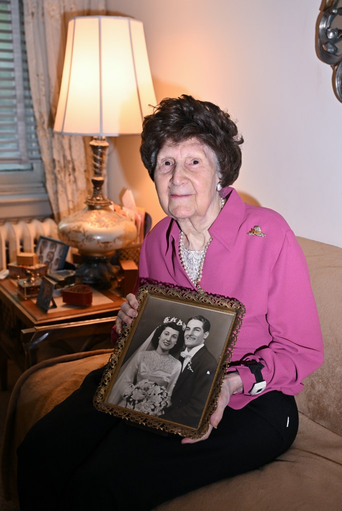 Nigro holding a photo of herself and her late husband Daniel.