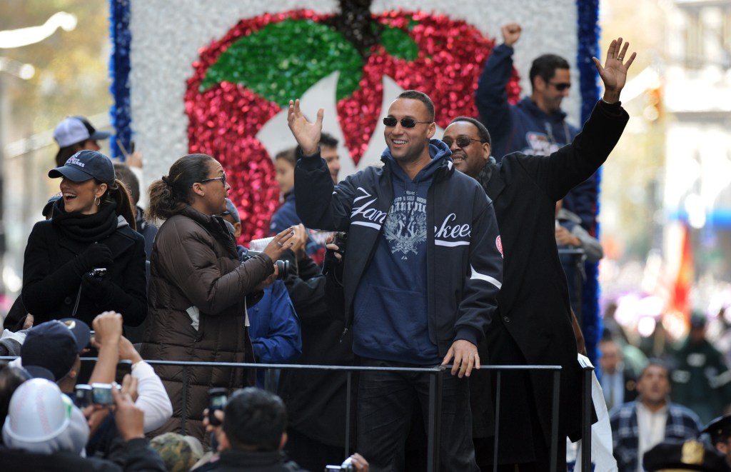 Derek Jeter rides with his family on a championship float down The Canyon Of Heros for a ticker tape parade after winning the 2009 World Series.