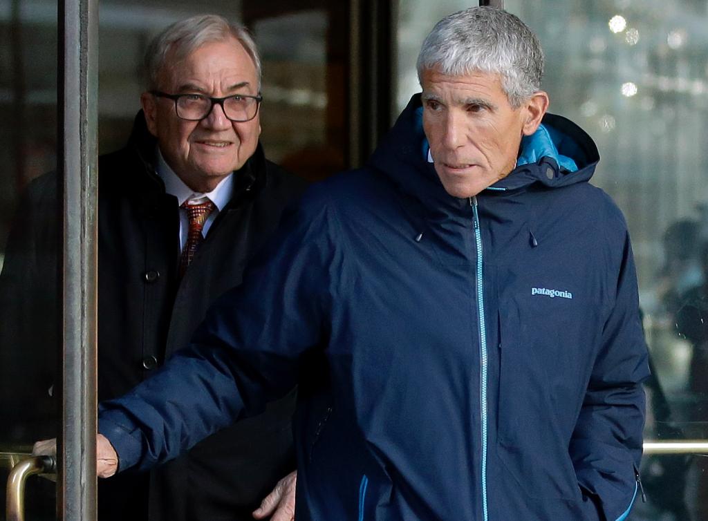 Singer leaves the Boston courthouse after he pleaded guilty to his charges on March 12, 2019.