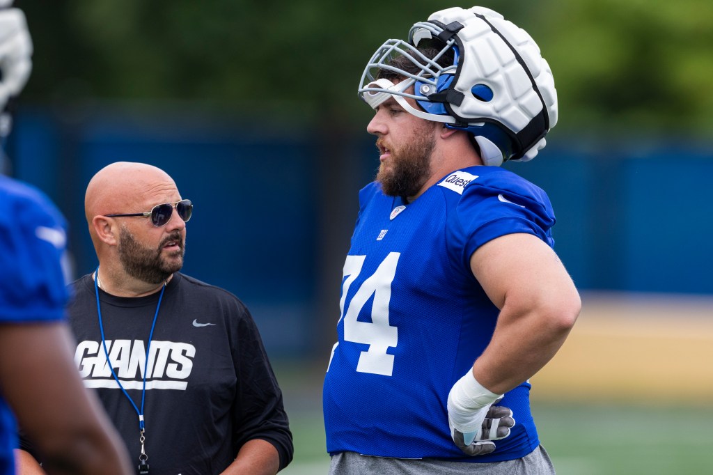 New York Giants head coach Brian Daboll  speaks to Greg Van Roten during training camp at the Quest Diagnostics center, Sunday, Aug. 4, 2024, in East Rutherford, New Jersey. 