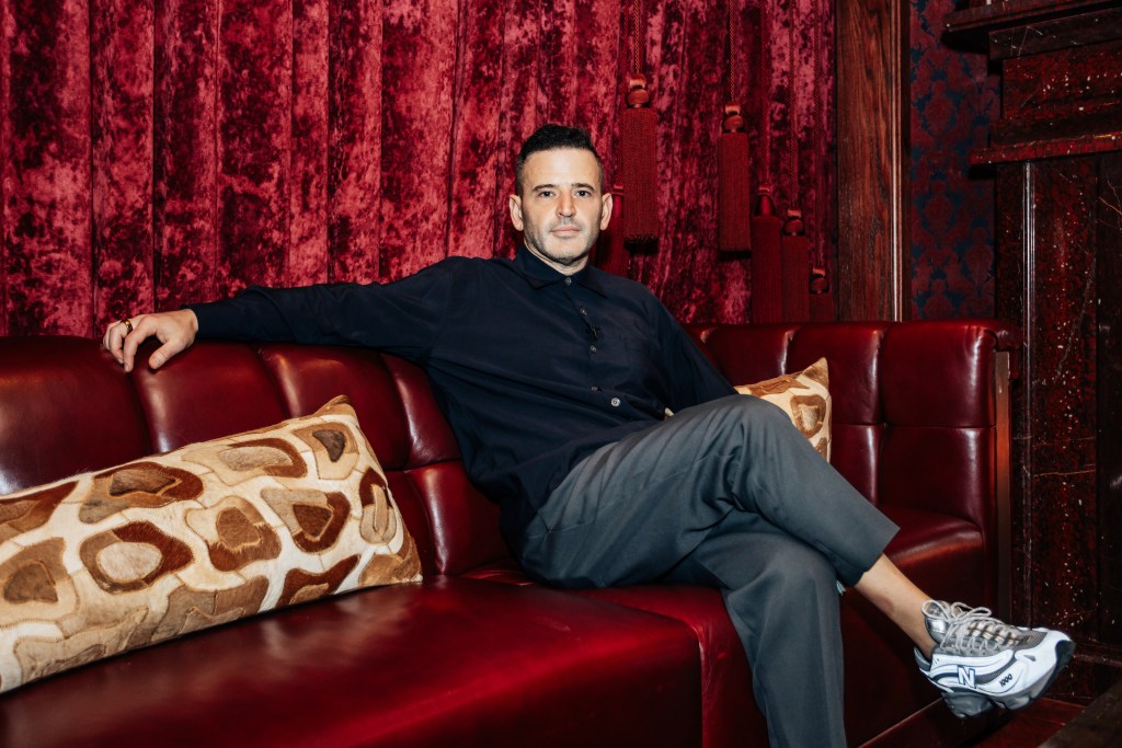 Eugene Remm sitting on a couch at Catch Steak (Red Room) in Manhattan, photographed on October 2, 2024 by Emmy Park for the NY Post.