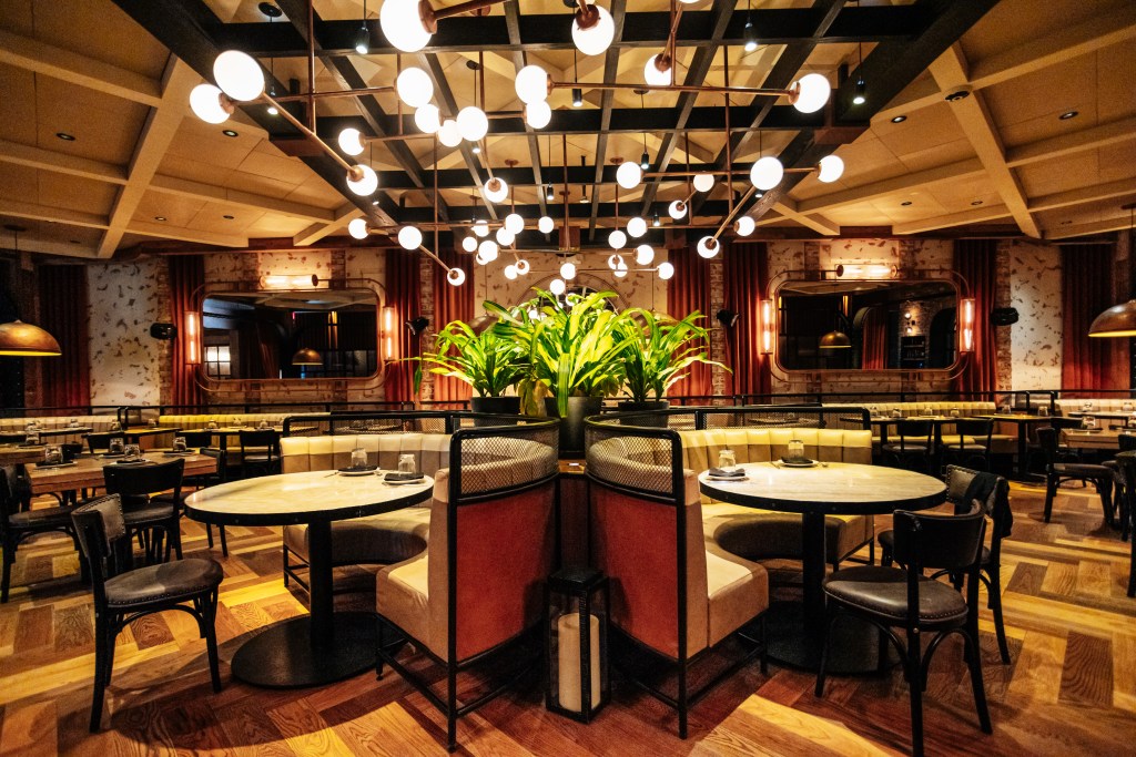 A well-set room with tables, chairs, and a plant at Catch Steak in Manhattan on October 2, 2024.