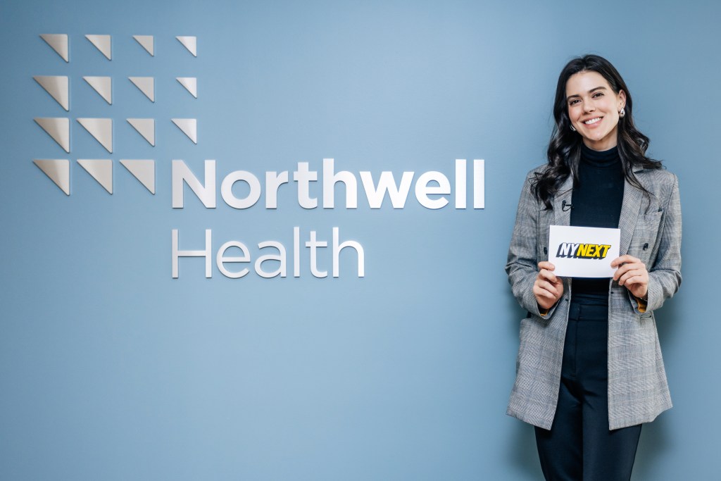 Lydia Moynihan holding a sign at Northwell's Corporate Headquarters in Manhattan, photographed on October 9, 2024 by Emmy Park for NY Post.