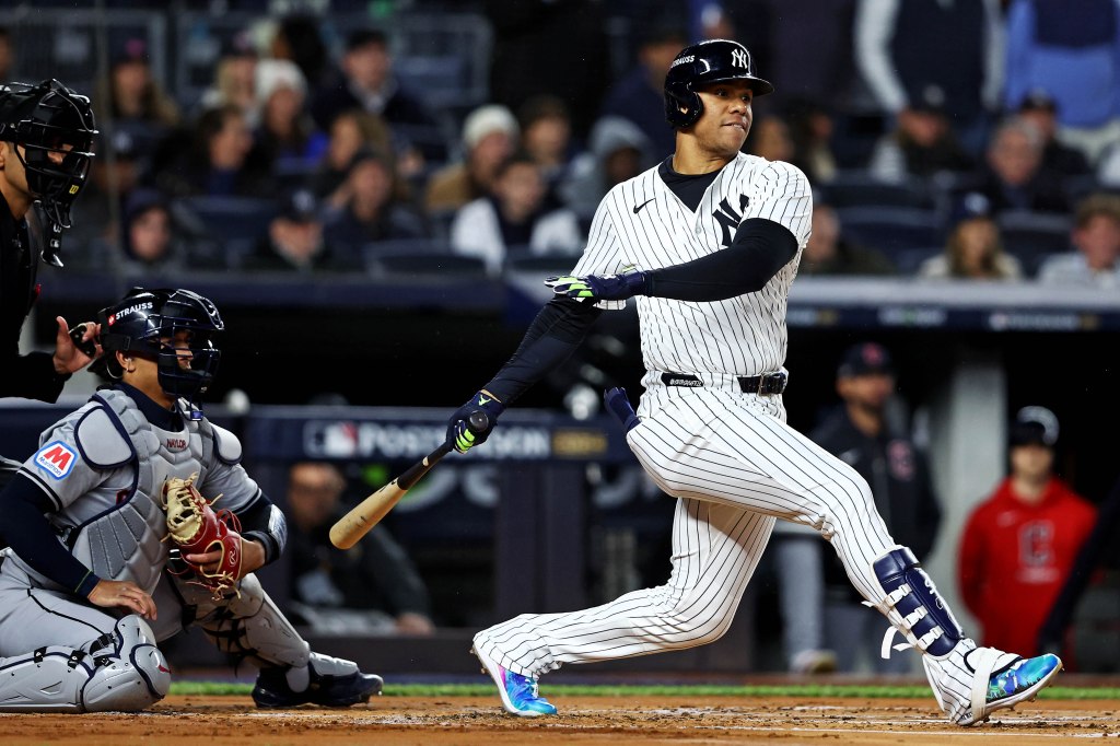 New York Yankees outfielder Juan Soto (22) hits a single during the first inning against the Cleveland Guardians in game two of the ALCS for the 2024 MLB Playoffs at Yankee Stadium.