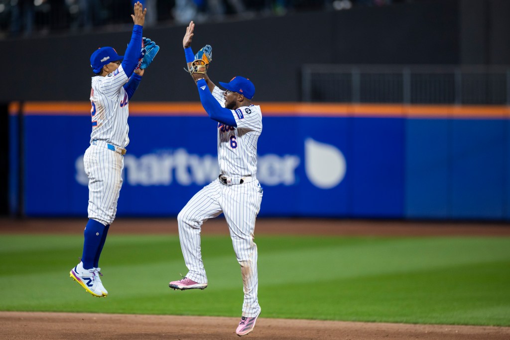 Francisco Lindor (12) celebrates with Starling Marte (6) after the final out of the 9th inning. The New York Mets defeat the Dodgers 12-6 in Game 5 of the 2024 NLCS at Citi Field, Friday, Oct. 18, 2024. 