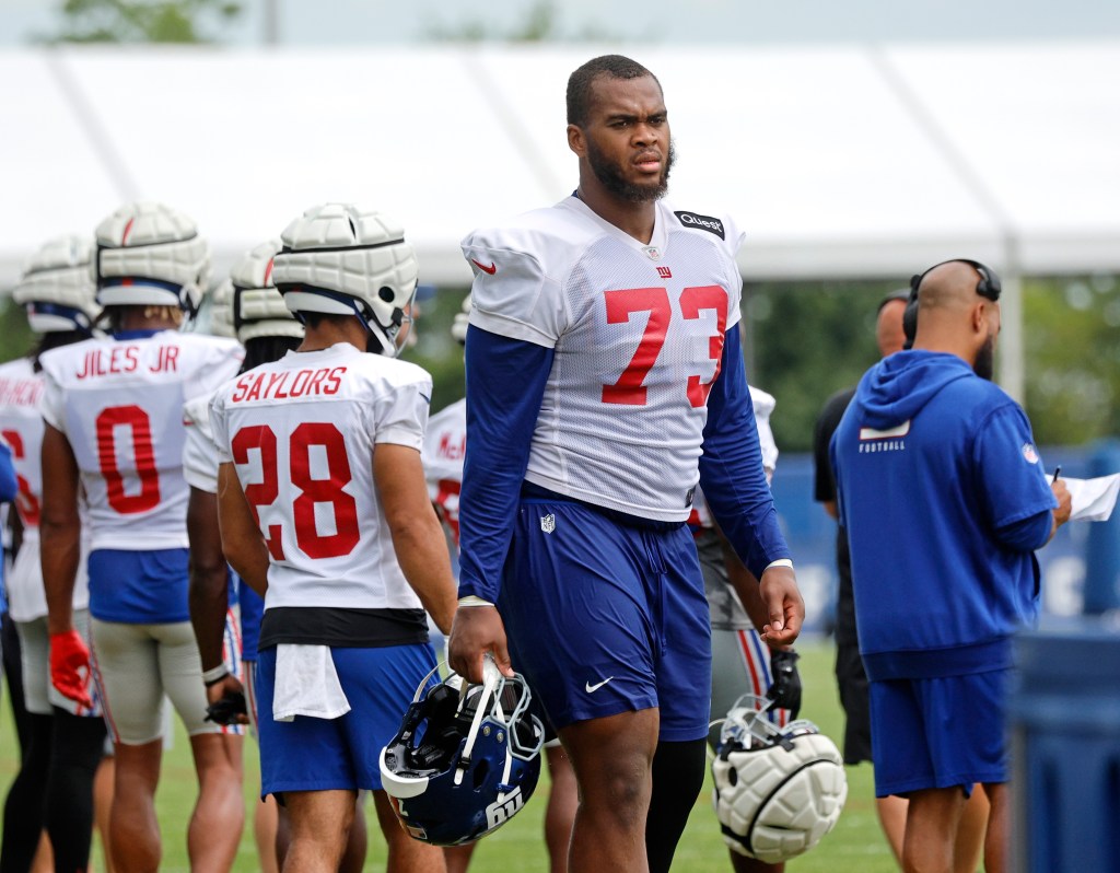 New York Giants offensive tackle Evan Neal #73 standing on the sidelines during practice at training facility in East Rutherford, New Jersey