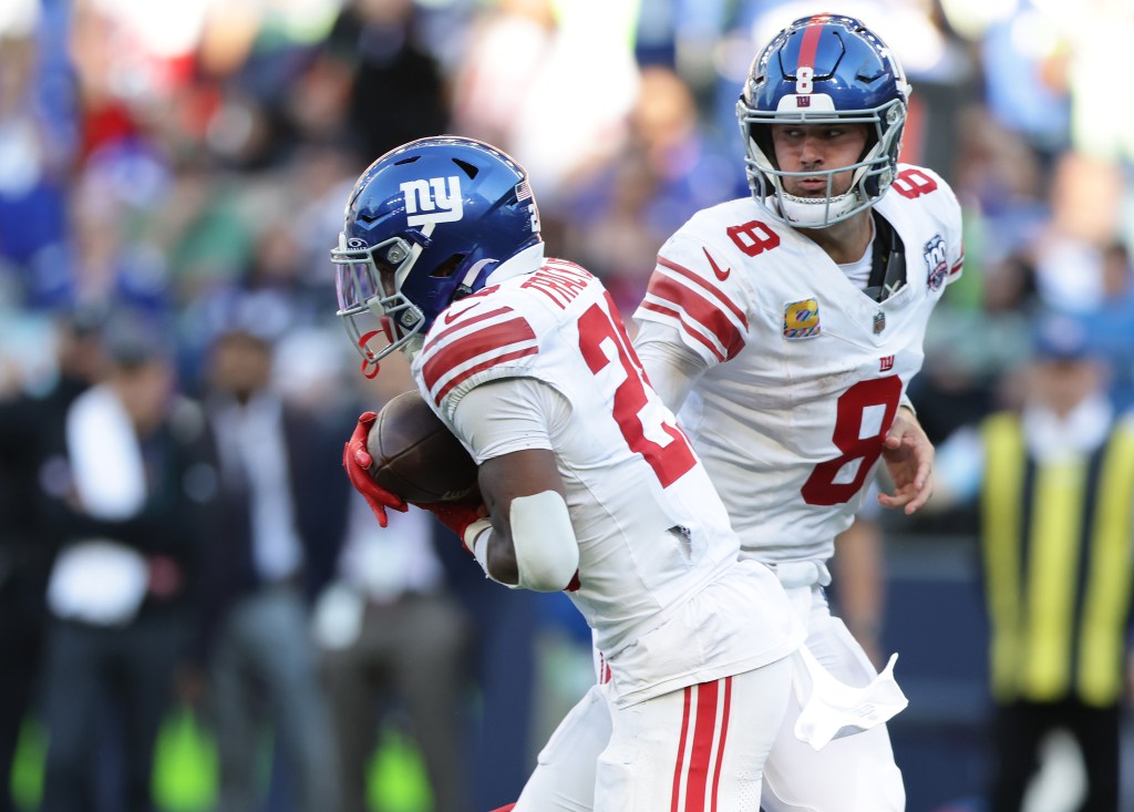 Tyrone Tracy takes a handoff from Daniel Jones during the Giants' win over the Seahawks on Oct. 6, 2024. 