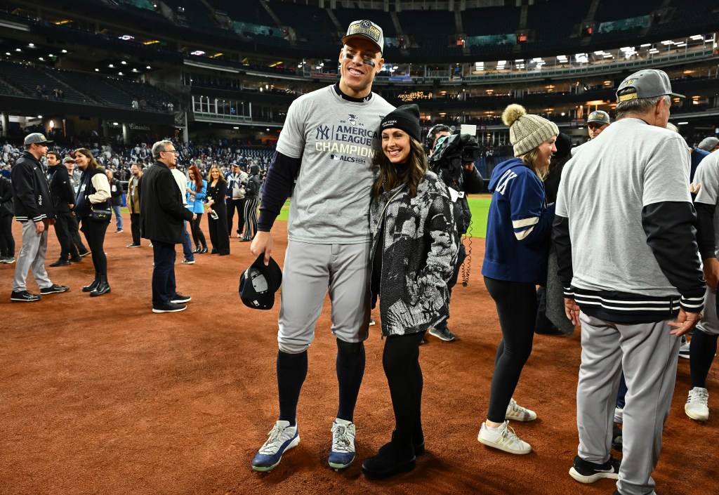 Yankees star Aaron Judge and wife Samantha Bracksieck pose for photos after New York beat the Cleveland Guardians 5-2 in Game 5 of the American League Championship Series at Progressive Field on October 19, 2024 in Cleveland, Ohio.  