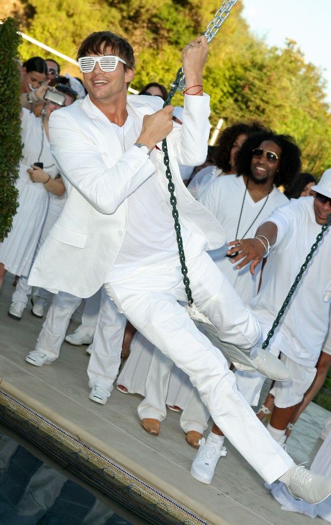 Actor Ashton Kutcher in a white suit at the White Party hosted by Sean 'Diddy' Combs, an event to raise awareness for Malaria No More