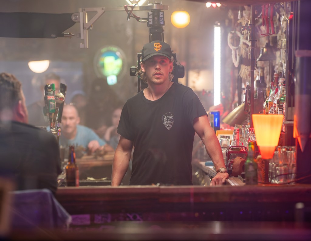 Austin Butler behind a bar shooting "Caught Stealing." 