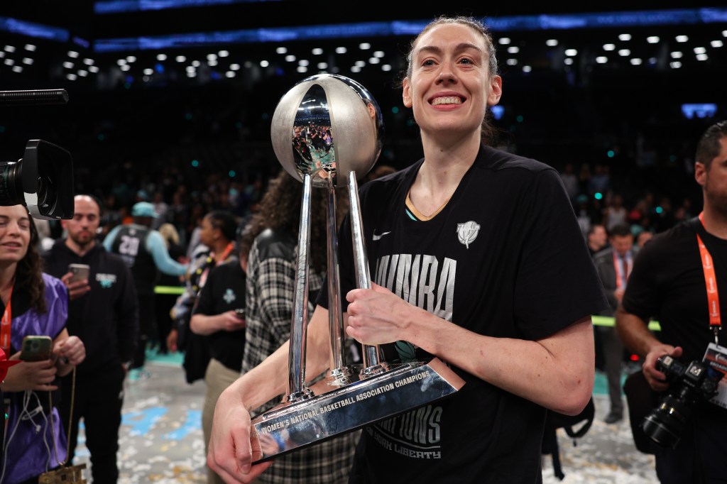 Breanna Stewart celebrates with the WNBA Championship trophy after the Liberty's win over the Lynx on Oct. 20, 2024. 