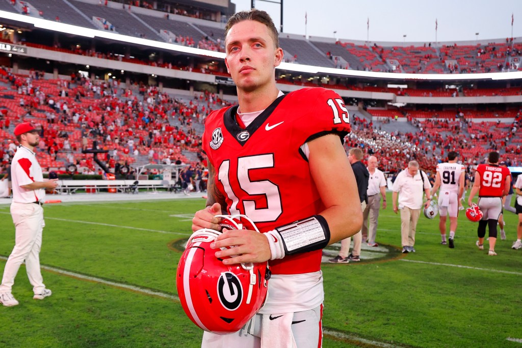 Carson Beck #15 of the Georgia Bulldogs leaves the field following the game against the Auburn Tigers at Sanford Stadium on October 5, 2024 in Athens, Georgia. 