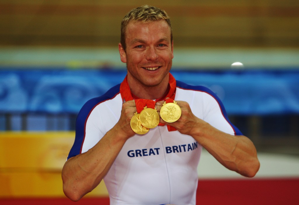 Hoy shows off his three medals he won at the 2008 Beijing Olympics.