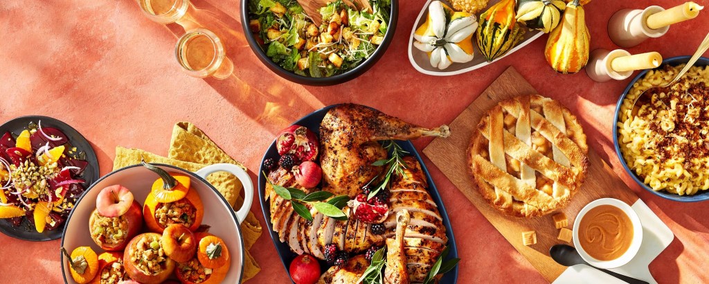 Table filled with budget Thanksgiving meal items from Target, including a Good & Gather Turkey