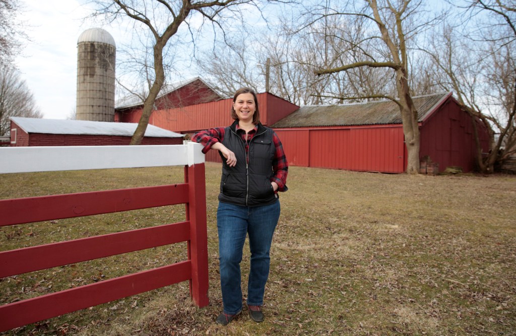 Democratic candidate Elissa Slotkin posing on her family farm in Holly, Michigan