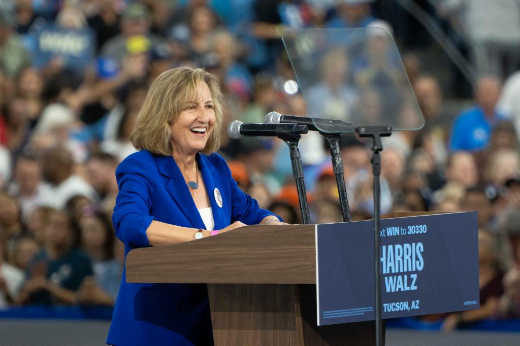 Democratic candidate Kirsten Engel speaking at podium during Get-Out-The-Vote rally alongside former President Barack Obama, in support of Kamala Harris