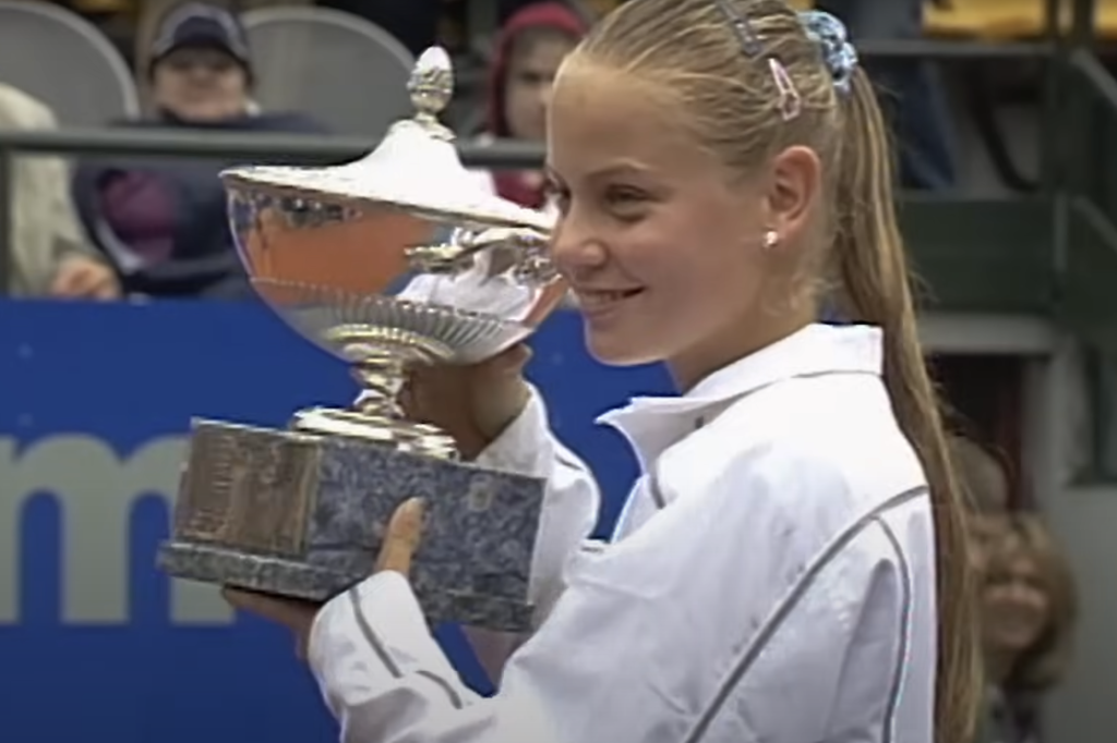 Jelena Dokic holding a trophy, reflecting on her struggles