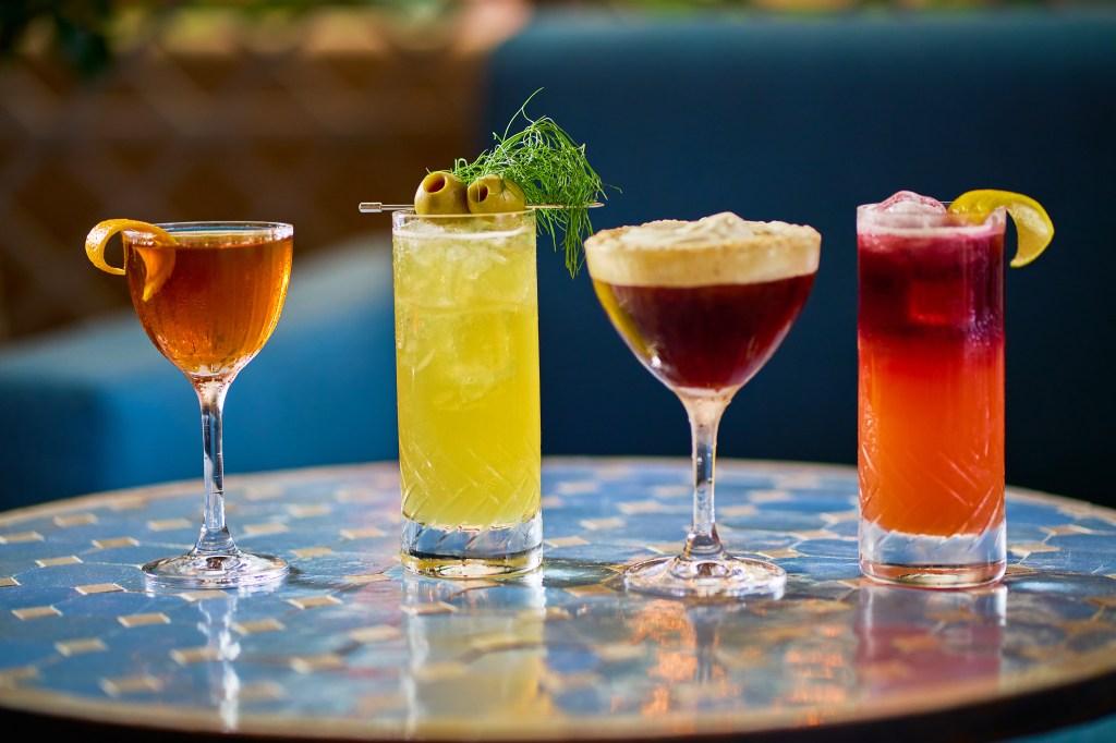 A group of drinks on a table at Bar Sprezzatura, illuminated by natural light