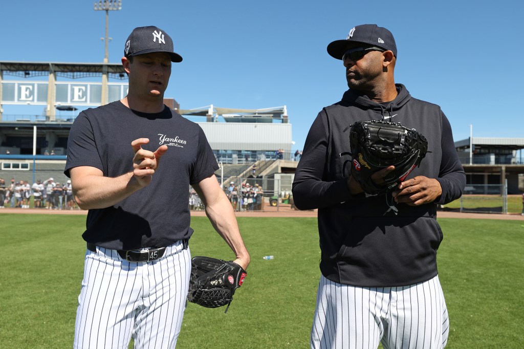 Gerrit Cole #45 of the New York Yankees talks with CC Sabathia during spring training at George M. Steinbrenner Field on February 22, 2024