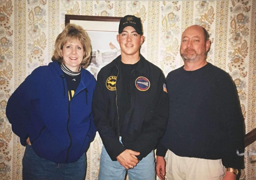 Lesley, Allen and George Sisler standing in front a wallpapered wall