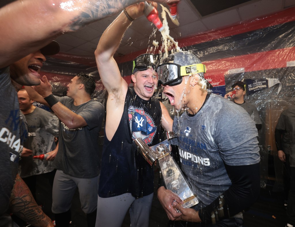 Juan Soto (r.) celebrates in the Yankees clubhouse after winning the AL pennant on Oct. 19, 2024.