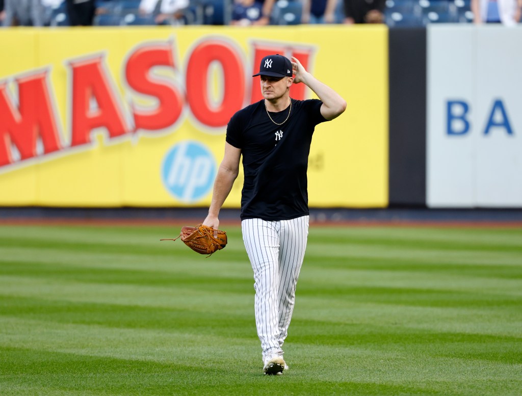 Yankees pitcher Clarke Schmidt on the field during batting practice before the start of Game 2. 