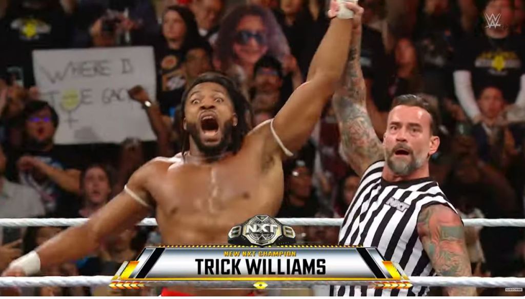 Trick Williams has his hand raised by CM Punk after winning the NXT championship on Oct. 1, 2024.