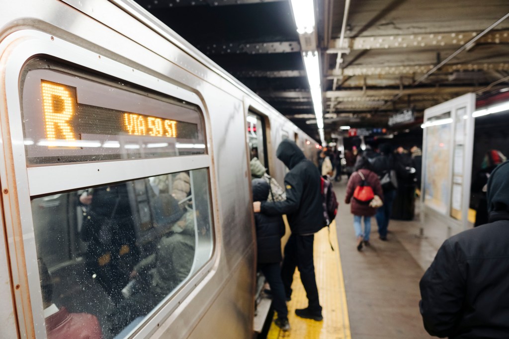 Commuters board the R train.