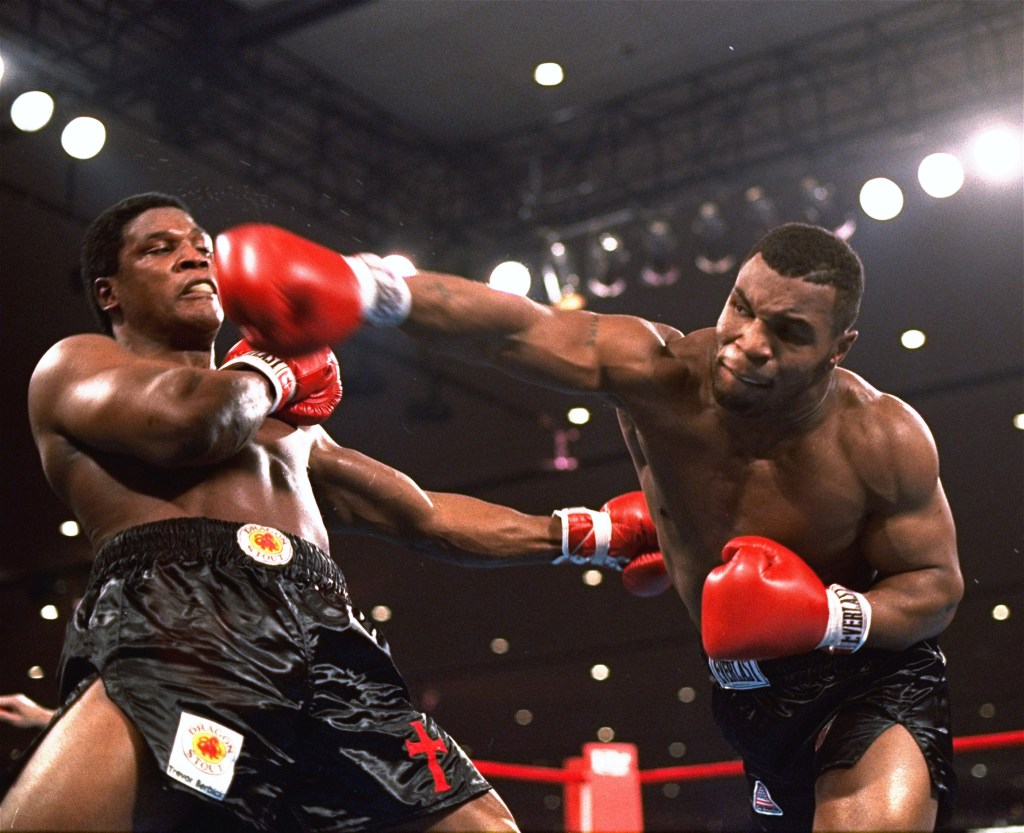 Mike Tyson (r) delivers a powerful blow to Trevor Berbick (l) in the second round of a fight on Saturday night, November 22, 1986, in Las Vegas. Tyson became the youngest heavyweight champion shortly after with a TKO.