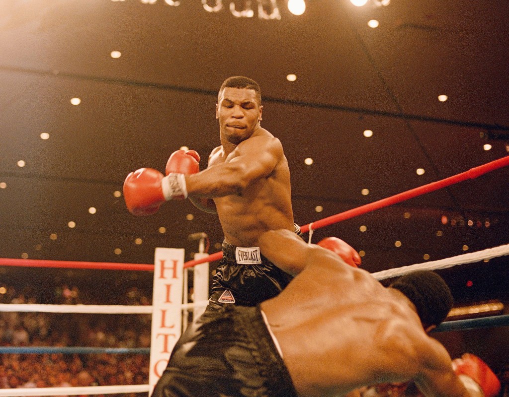 Mike Tyson knocks down Trevor Berbick on November 22, 1986. It took Tyson two rounds to become, at age 20, the youngest heavyweight champion ever.