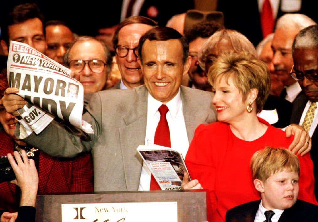 Giuliani holding a New York Post in 1993 saying he won the election standing in a crowd with his wife.