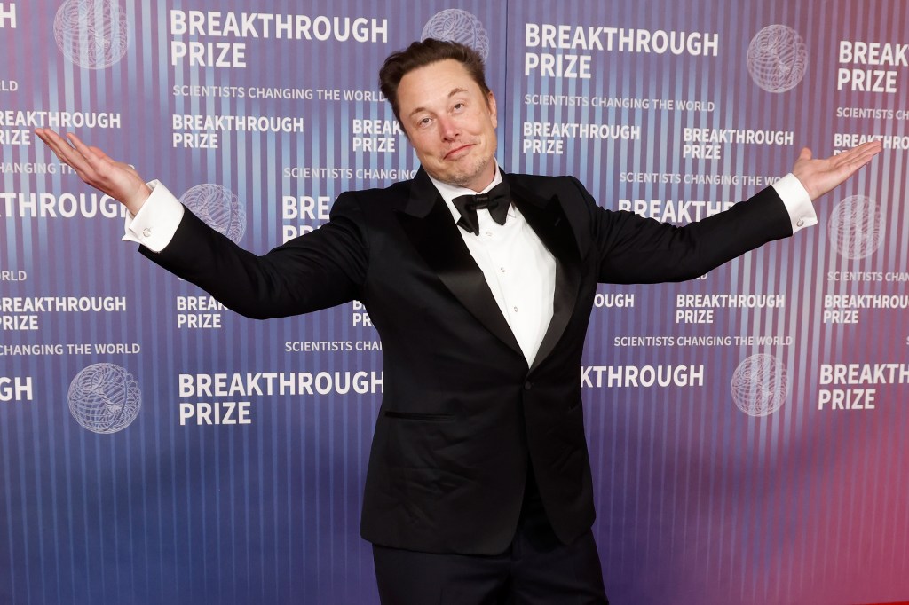 Elon Musk with smiling with arms outstretched at 2024 Breakthrough Prize Ceremony on April 13, 2024.