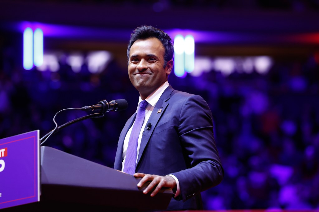 Vivek Ramaswamy speaking at a podium before Donald Trump's campaign rally at Madison Square Garden in New York City, 2024