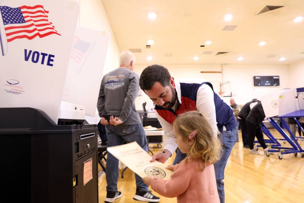 Republican Rep. Mike Lawler casts his ballot with two-year-old daughter Julianna on election day at St. Aedan's Church in Pearl River Nov. 5, 2024.