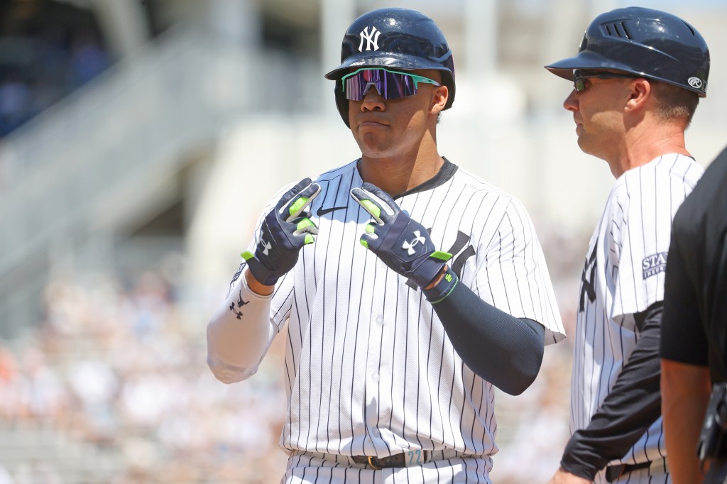 Juan Soto #22 of the New York Yankees reacts after hitting a single