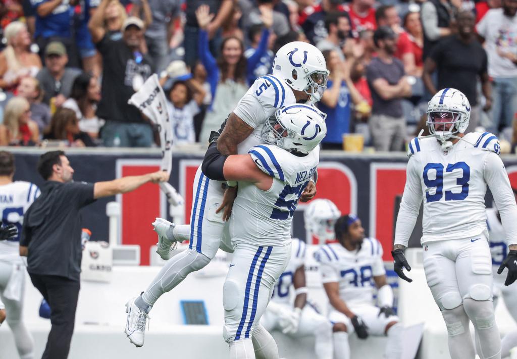 Anthony Richardson (5) celebrates with guard Quenton Nelson (56) after throwing a touchdown pass during the first quarter against the Houston Texans at NRG Stadium. 