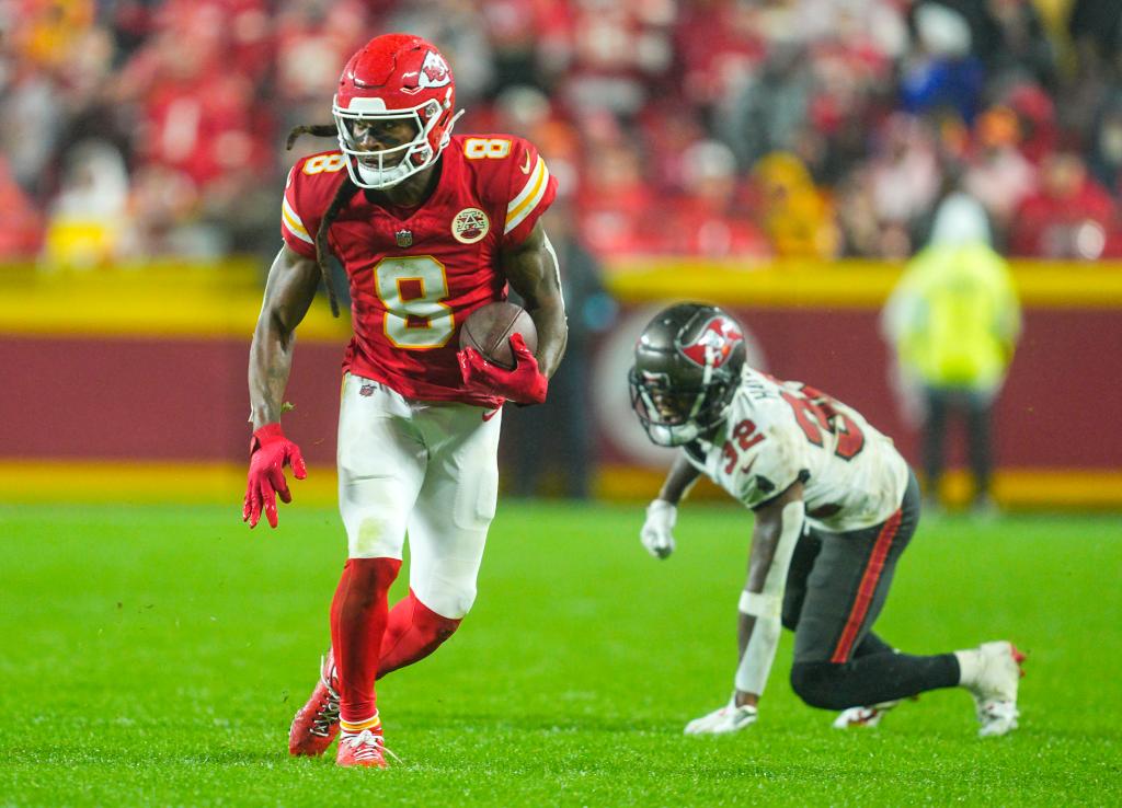 Kansas City Chiefs wide receiver DeAndre Hopkins (8) runs with the ball past Tampa Bay Buccaneers safety Josh Hayes (32) during overtime at GEHA Field at Arrowhead Stadium.