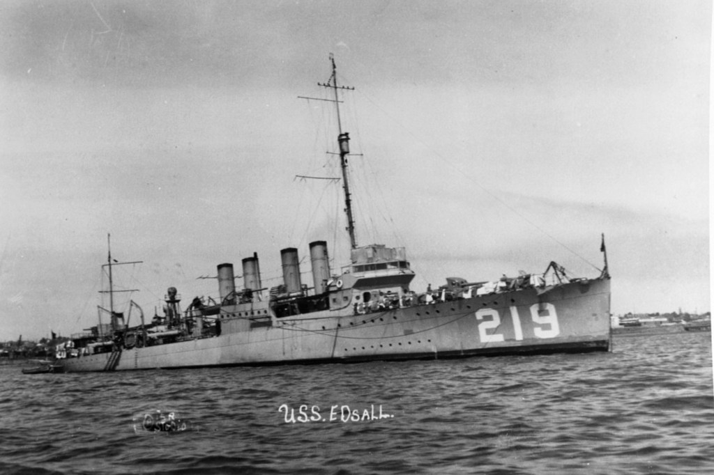 Archival black and white photo of the USS Edsell from the side.