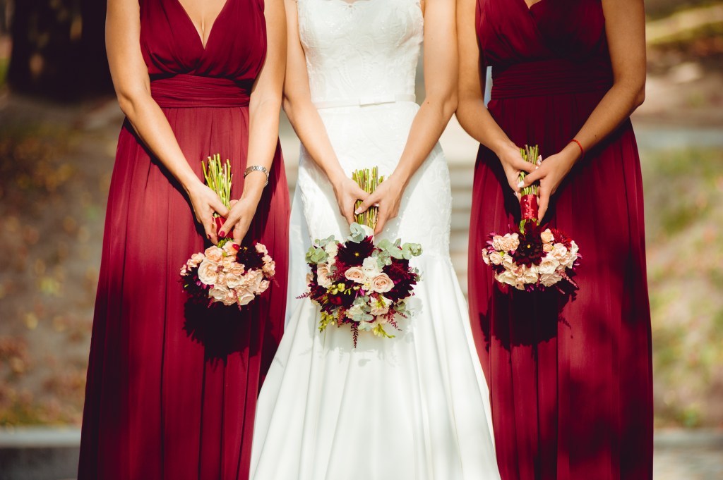 A bride and her bridesmaids with their bouquets upside down. 