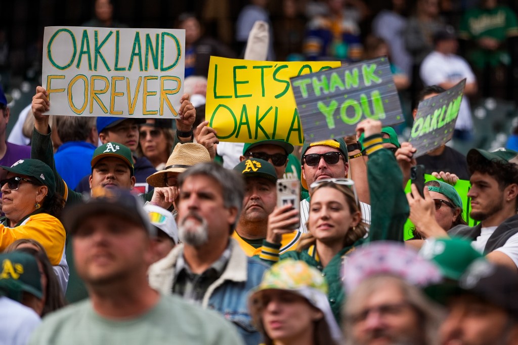 Oakland Athletics hold signs and chant in the stands following the Athletics' 6-4 loss to the Seattle Mariners in a baseball game, Sunday, Sept. 29, 2024, in Seattle.