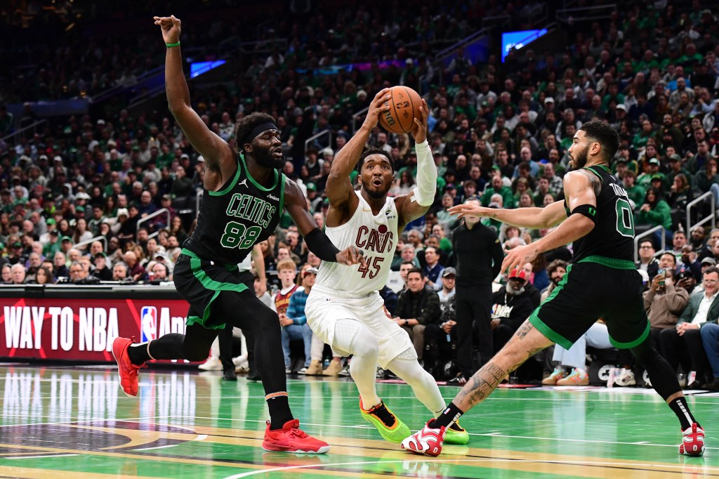 Donovan Mitchell drives to the basket between Neemias Queta (left) and forward Jayson Tatum during the Cavaliers' loss to the Celtics.