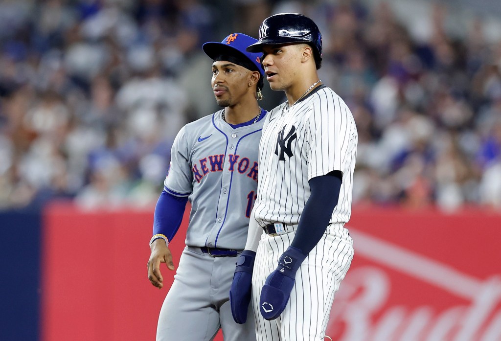 Juan Soto #22 of the New York Yankees stands at second base with Francisco Lindor #12 of the New York Mets during the fifth inning of their game at Yankee Stadium on July 24, 2024 