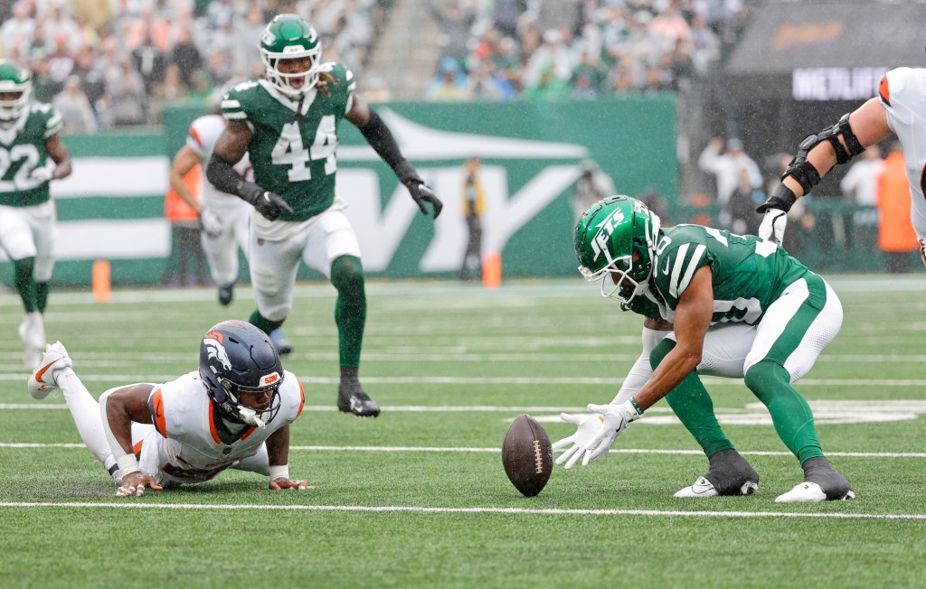 Michael Carter recovers a fumble during the Jets' 10-9 loss to the Broncos earlier this season.