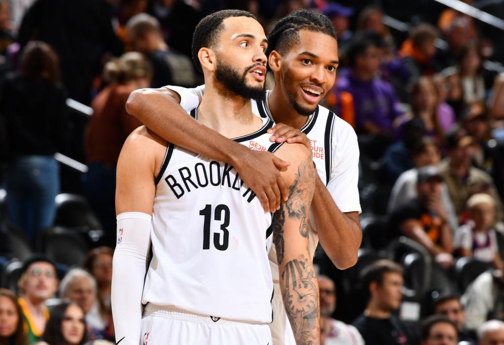 Ziaire Williams hugs Tyrese Martin during the Nets' win over the Suns.