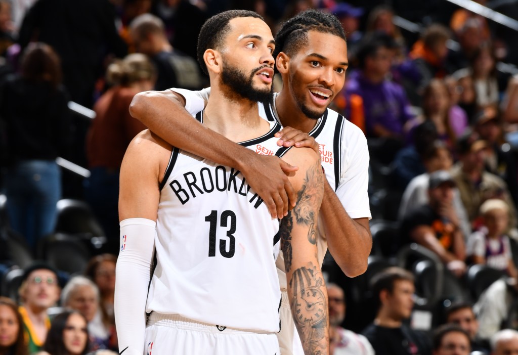 Ziaire Williams hugs Tyrese Martin during the Nets' win over the Suns.