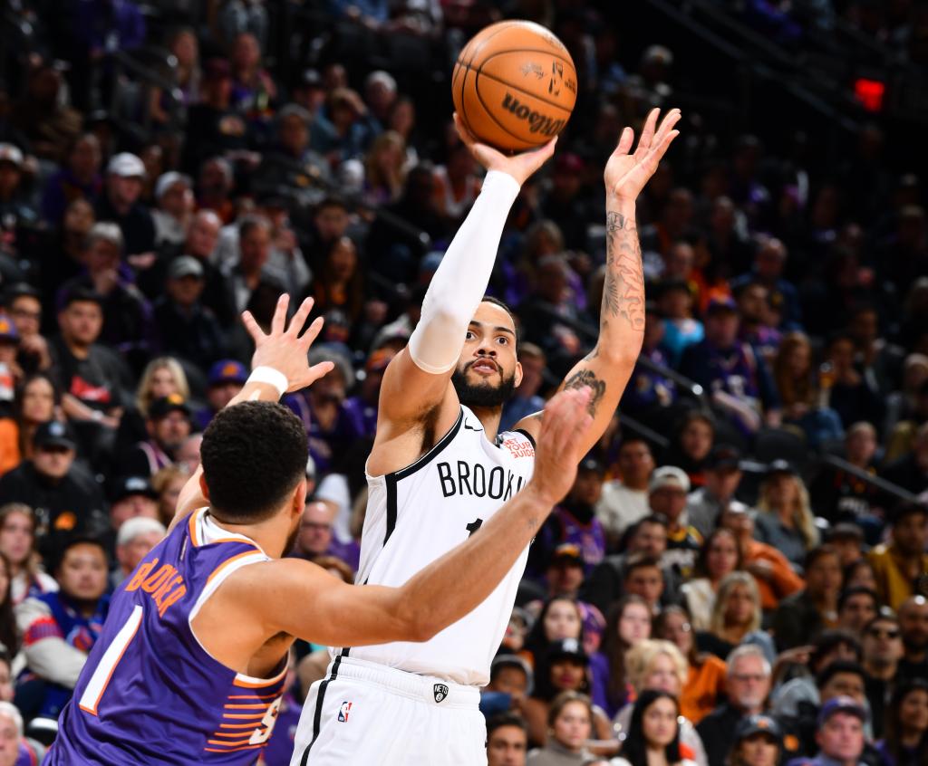 Tyrese Martin, who scored a team-high 30 points off the bench, shoots over Devin Booker during the Nets' win.