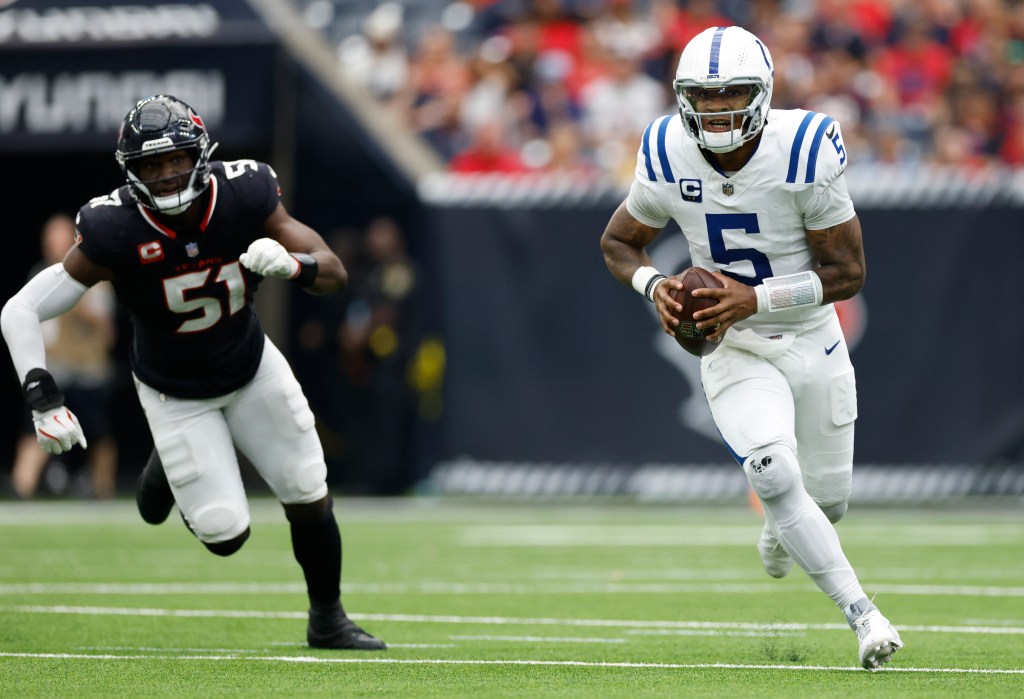 Anthony Richardson #5 of the Indianapolis Colts runs with the ball against Will Anderson Jr. #51 of the Houston Texans during the third quarter at NRG Stadium on October 27, 2024 in Houston, Texas. 