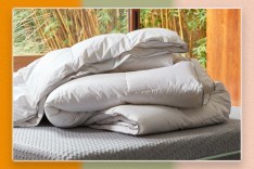 A pile of white blankets on a bed