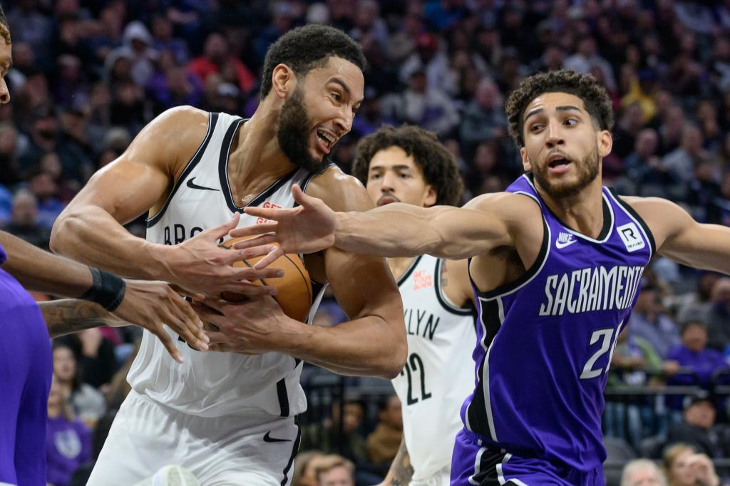 Brooklyn Nets guard Ben Simmons and Sacramento Kings guard Colby Jones battling for a rebound during an NBA game